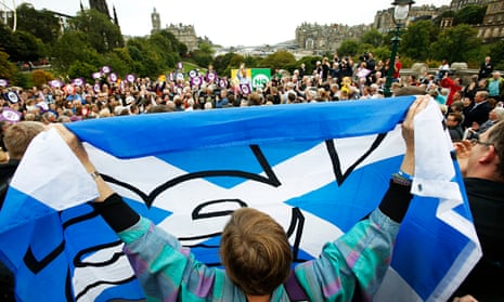 A yes supporter waves a saltire at Jim Murphy MP