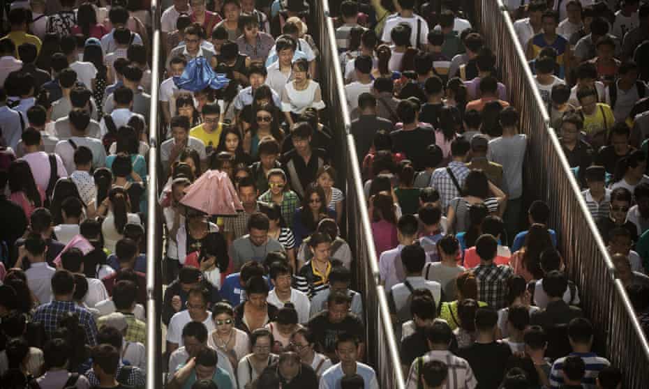 Chinese commuters line up for a security check to enter the Beijing subway system.