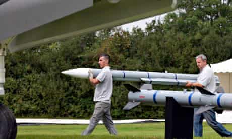 Workers carry a scale model of a missile