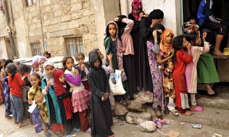 Yemeni children queue at a charity centre 