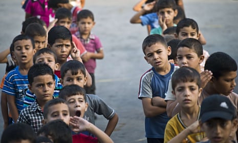 Children line up in the courtyard of a UN school in Gaza last month