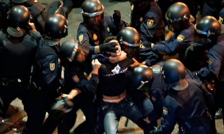 A demonstrator struggles with Spanish police
