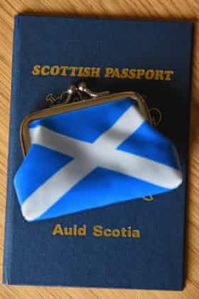 A Scottish passport holder and purse.