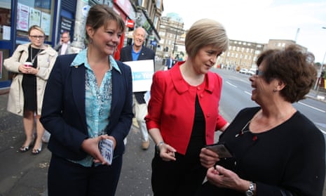 Scotland's Deputy first minister, Nicola Sturgeon, and Plaid Cymru Leanne Wood (foreground, left), stop to talk to a woman whilst on a walk-about in Glasgow yesterday.