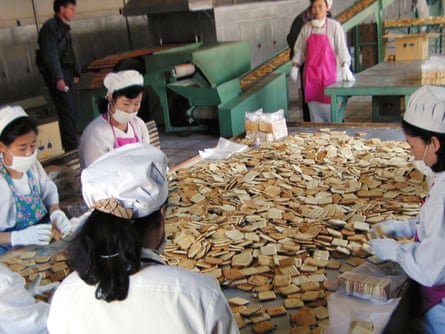 North Korean workers pack vitamin-and mineral-enriched biscuits at a factory in Sinuiju city, North Korea.