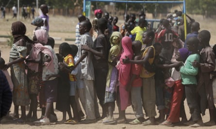 Children left homeless after attacks by Boko Haram line up in a displaced people camp in Yola, Nigeria