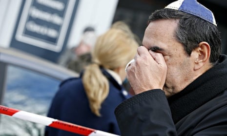 A man  wearing kippa cries near a kosher