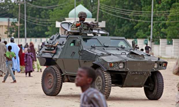 A Nigerian soldier patrols in an armoured vehicle in Maiduguri, Nigeria
