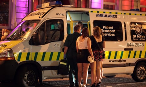 Revellers talk to a friend being treated in an ambulance outside a Cardiff night spot.