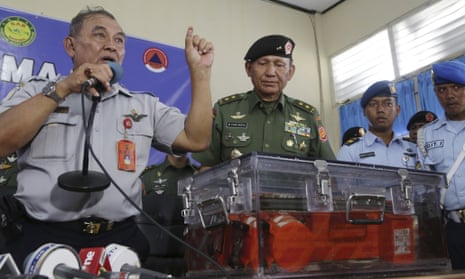 Chief of the National Transportation Safety Board Tatang Kurniadi, left , speaks to the media during a press conference presenting one of the black boxes of AirAsia Flight 8501.