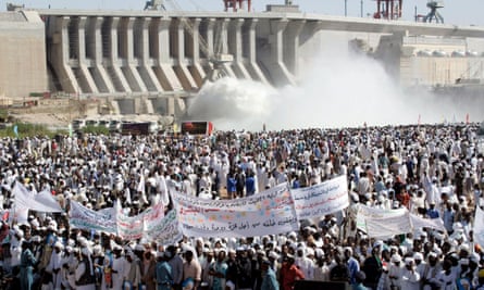 Hundreds of Sudanese holding banners supporting their President Omar Al-Bashir during the inauguration of the massive hydro-electric dam in Merowe, north of Khartoum, on 3 March 2009.