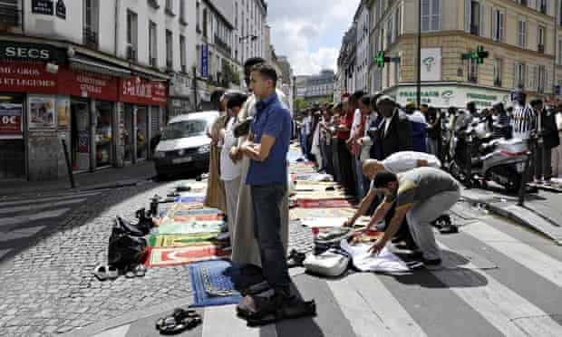 Muslims pray outside a mosque in Paris in 2011