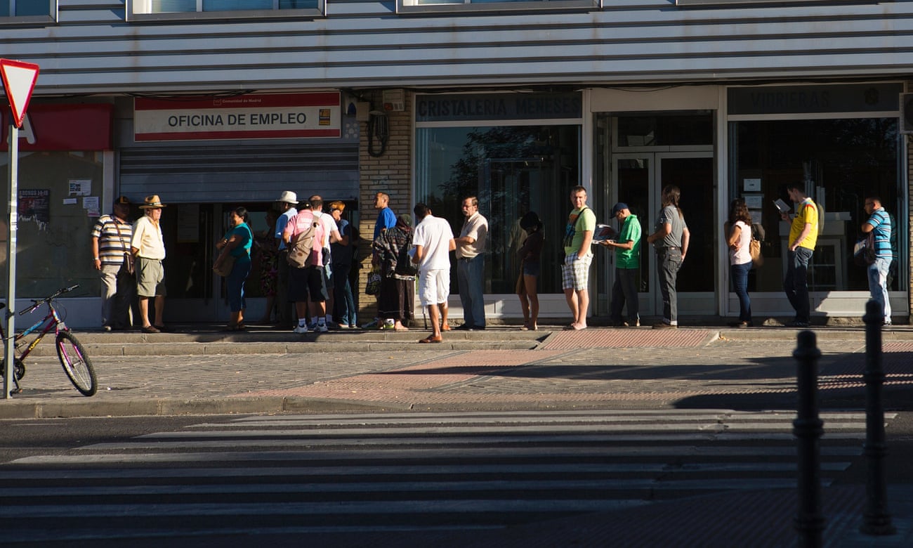 Jobseekers wait in a queue outside an employment centre in Madrid, Spain.
