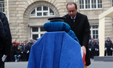 The French president, François Hollande, stands in front of the coffin of police officer Ahmed Merabet during a national tribute for all the police officers killed last week.