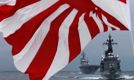 Japanese Maritime Self-Defense Force destroyer Kurama (R) leads destroyer Hyuga as a Japanese naval flag flutters during a naval fleet review at Sagami Bay, south of Tokyo.