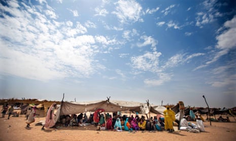 Sudanese women and children rest at the Kalma refugee camp for internally displaced people, south of the Darfur town of Nyala, Sudan, in March 2014.