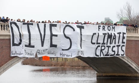 A "Divest from climate change" banner is dropped over the Charles River by Boston students who aim to stop climate change by having their schools divest from the fossil fuel industry, 8 December 2013 .