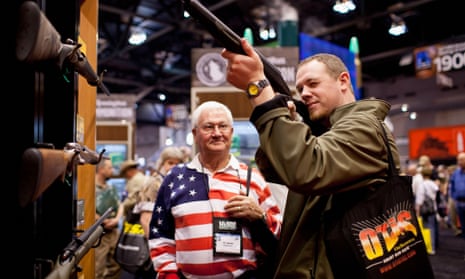 Pat Darling, left, and his nephew, Chip Darling, look at a rifle at NRA meeting in St Louis, Missouri in 2012.