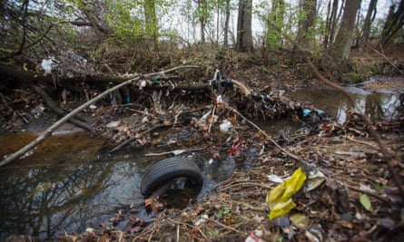 Trash accumulates on Nash Run, a creek that empties into the Anacostia River, in Washington DC, US, 4 December 2014. Environmental groups routinely list the Anacostia as one of the most polluted waterways in America.