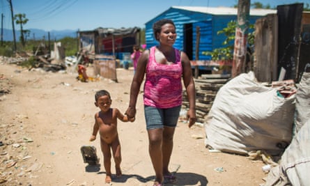 'I like living here' ... Mara Lucia Feitosa with one of her 12 children, in Esqueleto. Photograph: Lianne Milton