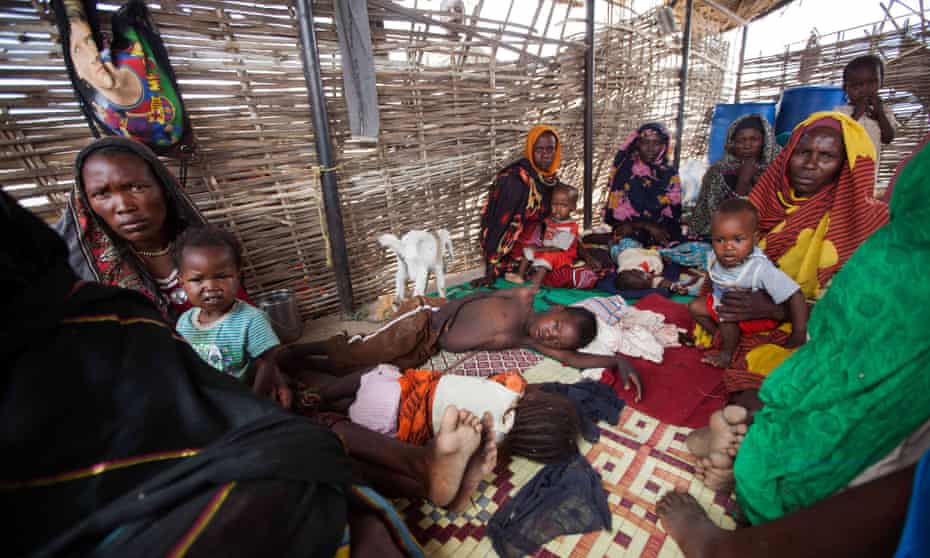 Women and children shelter at the al-Salam camp in South Darfur, Sudan, where women have been disproportionately affected by rice has increased. 