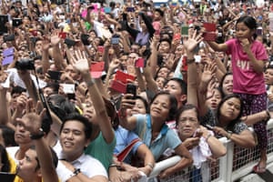 Thousands of the faithful strain to see Pope Francis as he arrives at the cathedral