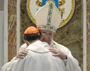 The pope hugs Cardinal Luis Antonio Tagle at the end of the mass