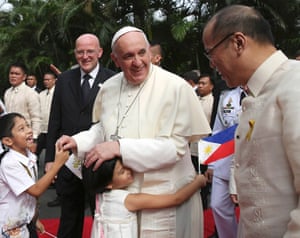 A girl embraces the pope after a welcoming ceremony at the Malacanang Palace in the capital