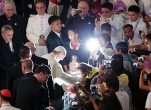 Pope Francis blesses a devotee during the meeting