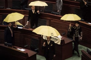 Pro-democracy members of the Hong Kong legislative council walk out in protest before Hong Kong leader Leung Chun-ying’s policy speech. Leung took a hard line warning pro-democracy protesters that they risk sparking anarchy, as he sought to bolster his support in his first policy address since demonstrations rocked the financial hub last year.