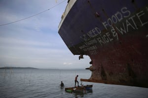 Divers take a part in efforts to recover a ship brought inland by typhoon Haiyan in Tacloban in the Philippines. On his first trip to Asia’s largest Catholic nation, Pope Francis visited Leyte, which is still struggling to recover from the typhoon that killed 6,300 people in 2013