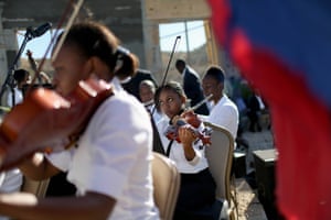 Musicians play during a ceremony to remember those killed by the 2010 earthquake in Haiti and buried in a mass grave at Titanyen. The service took place on the fifth anniversary of the quake, which killed up to 316,000 people in Port-au-Prince.