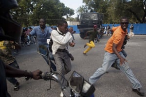 Again from Port-au-Prince, demonstrators run during a protest demanding the resignation of President Michel Martelly. Thousands of Haitians marched in protest and clashed with police in the capital.