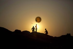 Photographer Muhammed Muheisen, whose work documents the displaced in Pakistan, captures an image of Afghan refugee children chasing a balloon on the outskirts of Islamabad