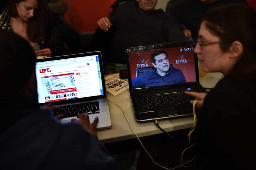 Activists watch an interview with Syriza leader Alexis Tsipras newspaper at the party's election centre in Athens last week.