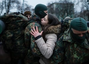 Ukraine, Kiev  A recruit to the  Azov battalion embraces his partner before he and other volunteers depart for the frontline in their battle with separatist forces in the east of the country