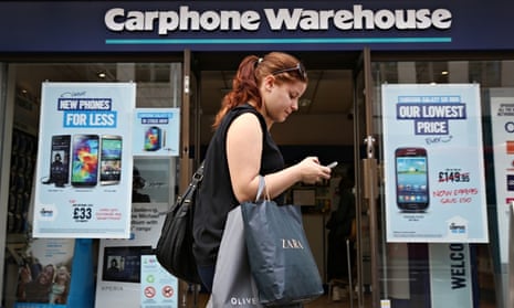 Woman walks past a branch of Carphone Warehouse
