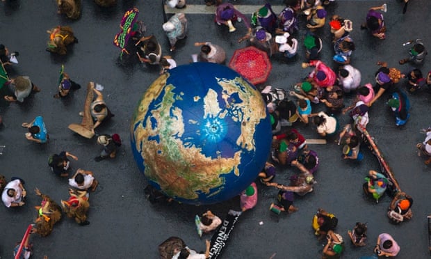 Activists push an inflatable globe during a "Global March" as part of the People's Summit for Social and Environmental Justice in Defense of the Commons, a parallel event during the UN Conference on Sustainable Development, or Rio+20, in Rio de Janeiro, Brazil, June 20, 2012.
