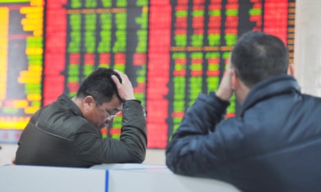 Investors falling share prices at a Chinese stockbroker firm's office in Fuyang, Anhui province.