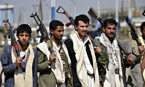 Armed members of Houthis gather at Sebin Square as they close the Sebin Road to traffic near preside