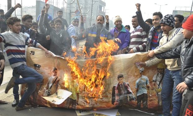 Protester burn a poster of the film PK outside a cinema in Ghaziabad, India