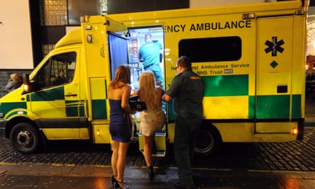 A woman is led into an ambulance in Concert Square, Liverpool, in the early hours of New Year's Day.