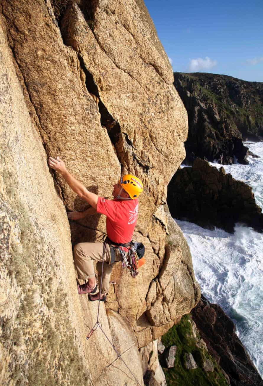 British mountain guide Steve Monks climbing the granite cliffs at Bosigran, West Penwith, Cornwall, UK
