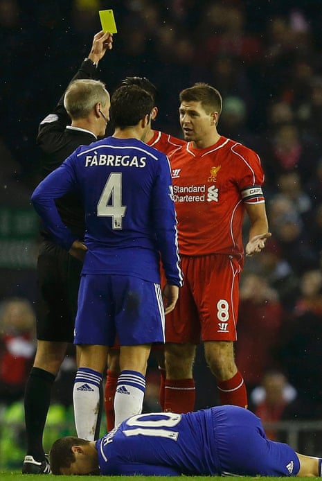 Steven Gerrard is booked by referee Martin Atkinson for the challenge on Eden Hazard.