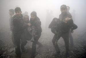 Douma, Syria Men carry injured victims following a reported air strike on the besieged rebel-held town, which faces frequent aerial and tank bombardment and the siege means food is scarce and medical facilities are ill-equipped to handle either illness or injury