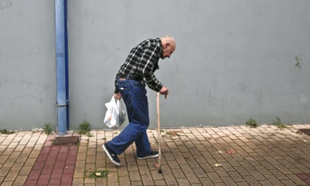 A man holds a bag with food as he leaves a New Year's meal for the homeless in Athens.