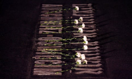 White flowers are placed on a plaque for the Auschwitz death camp, which is made from tiles and in the floor of the 'Hall of Remembrances' in the Yad Vashem Holocaust Memorial in Jerusalem