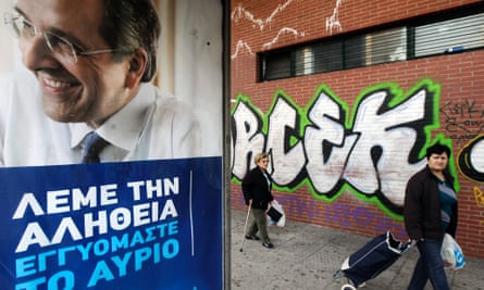People walk past an election poster of Greek prime minister Antonis Samaras in Athens.