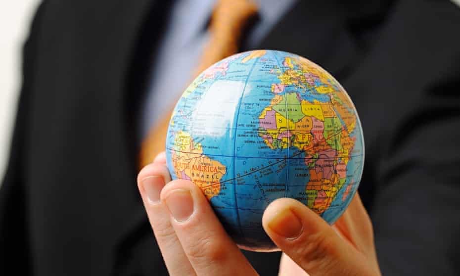Businessman holding a globe in his hand
