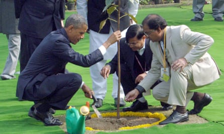 The US president plants a sapling after placing a wreath at the Mahatma Gandhi memorial.